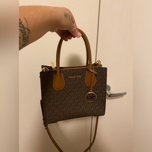 Michael Kors logo and leather crossbody purse.